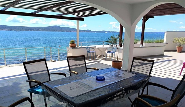 Amazing two storey holiday home with 120m roofed terrace, directly on the beach!